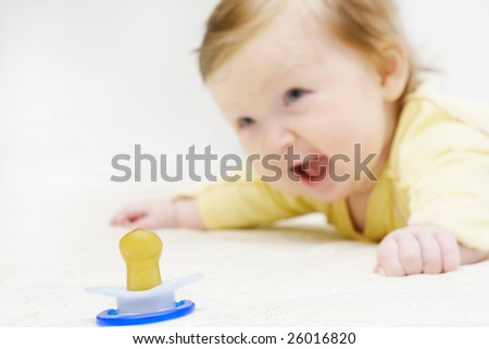 baby is asking loudly: Give me my pacifier! Focus on a pacifier