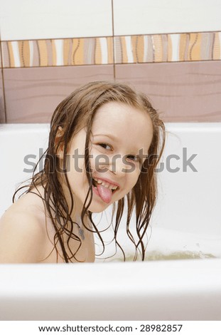 Joying Little Girl With Wet Hair Sticking Out Her Tongue Sitting At The ...