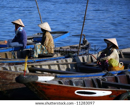 Vietnamese Fishermen waiting to go fishing by the Mekong River, Vietnam.