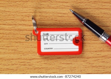 Name tag  and a pen on wood ground