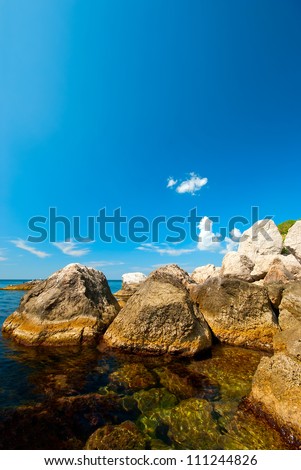 Coast of the Black Sea. Large boulders in the sea. Natural daylight landscape