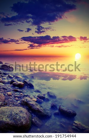 natural sea sunset. The sun sets behind the horizon. Vintage style