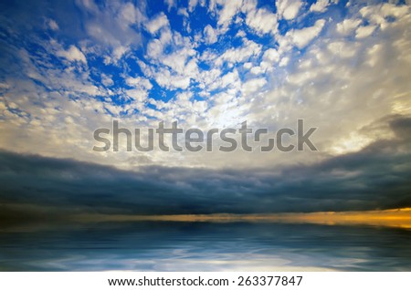 Storm clouds over the sea and light cirrus clouds in the foreground. natural composition