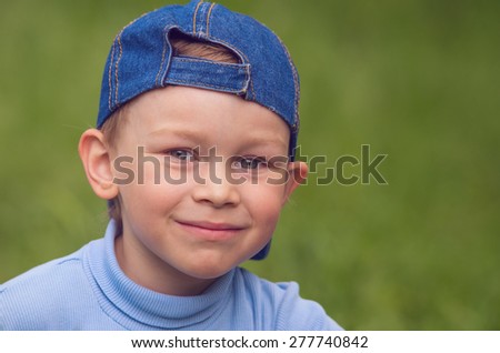 Little boy in denim cap looks directly. Vintage Family composition