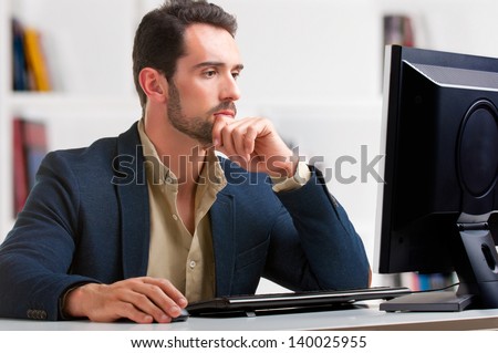 Man looking at a computer screen, thinking about the job at hand