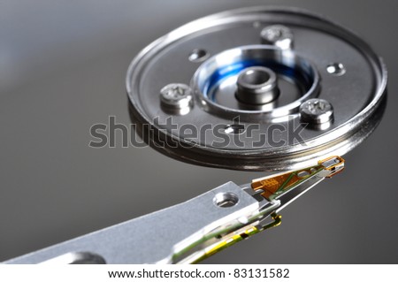 A close-up of and hard disk drive head