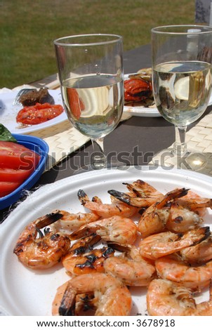 Grilled shrimps with white wine. Summer picnic.