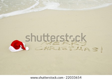 Santa's hat on a beach with Merry Christmas text