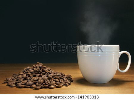 steaming hot coffee and coffee beans