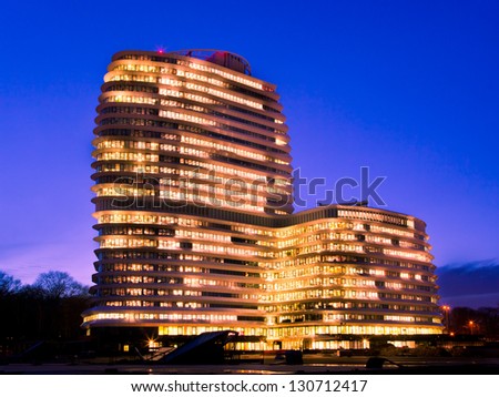 Long Working Hours in a Tall Modern Office Building with Lights during the Blue Hour
