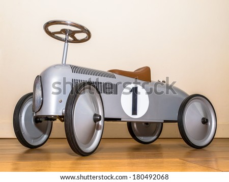 Silver Toy Push Car Against White Wall
