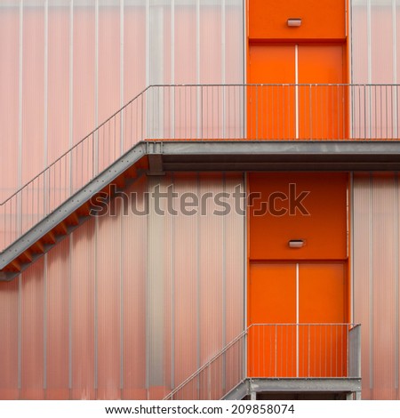 Fire escape stairs on the outside of a modern sports hall