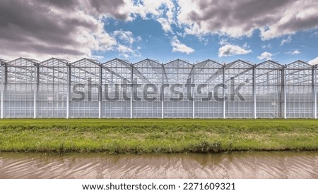 Similar – Foto Bild Glasgewächshausdächer bei bedecktem Himmel