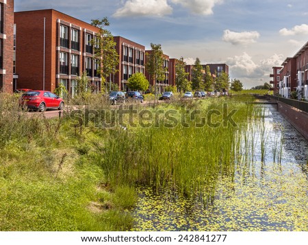 Modern ecological Street with middle class family apartments and eco friendly river bank in Wageningen city, Netherlands