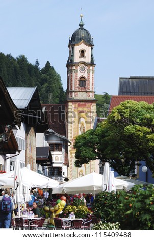 MITTENWALD, GERMANY - SEPTEMBER 11. Tourists in the pedestrian area of Mittenwald, Germany on September 11, 2012. Mittenwald is famous for the manufacture of vilins and cellos since the 17th century.