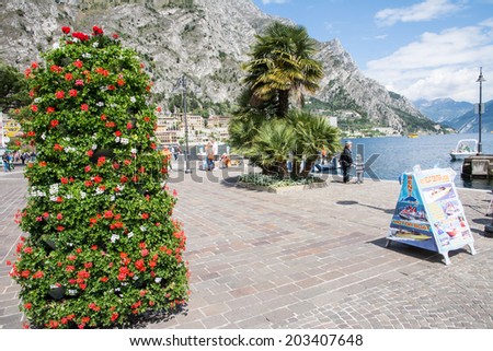 LIMONE, ITALY - APRIL 22: Tourists at the pedestrian area of Limone, Italy on April 22, 2014. The town at Lake Garda is famous for the cultivation of lemons. Foto taken from the water front in Limone.