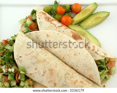 Fresh tortilla salad wrap with avocado and tomato