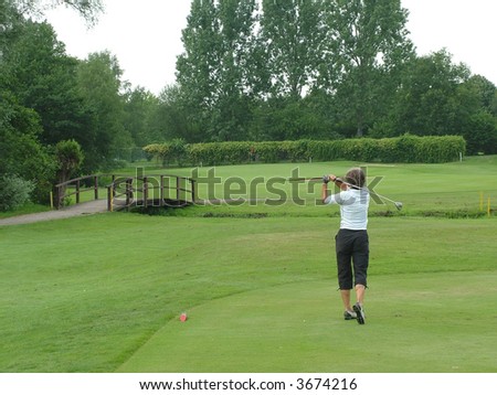 A fit 60 year old woman playing golf