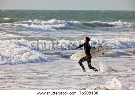 SAN FERNANDO, CADIZ, SPAIN - FEB 19: Unknown surfer going to the water on the 2nd championship of Surf and BodyBoard Impoxibol on Feb 19,2011 on the beach of Camposoto of San Fernando, Cadiz, Spain