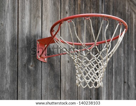 a basketball basket on weathered wooden facade