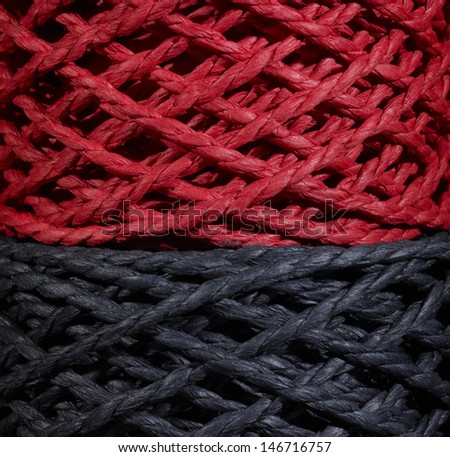 detail of two stacked red and black string coils