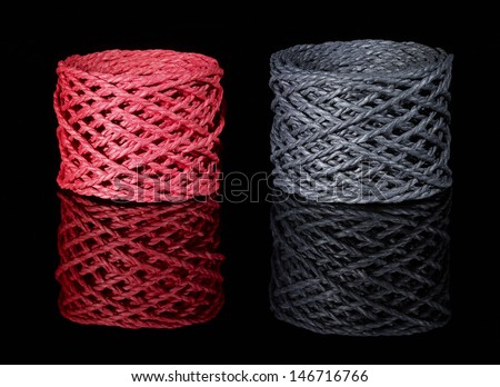 a red and a dark grey string coil in black reflective back