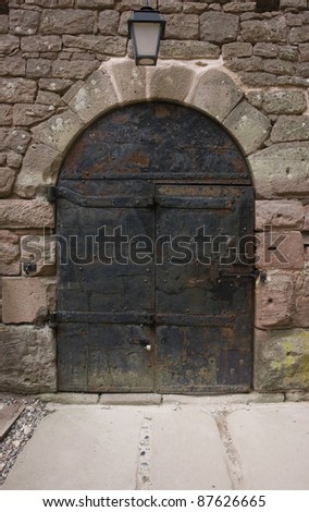 old weathered door at a entrance of the Haut-Koenigsbourg Castle, a historic castle located in a area named \