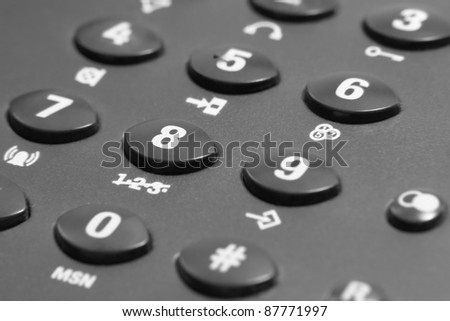 full frame closeup of a dark grey phone keypad