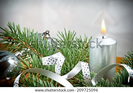 a Christmas candle with silver background
