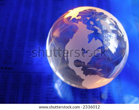 glass globe on blue stock market and financial figures with orange highlights