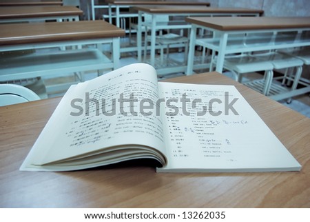 open chinese learning book on a table in a classroom