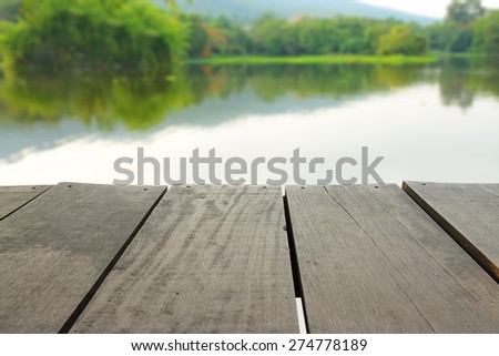 Defocus and blur image of Terrace wood and pond in public park for background usage