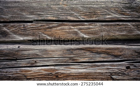 fragment of the old country house of natural wooden timbers without coloring with a number of snags