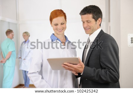 Businessman with Female Doctor at the Hospital
