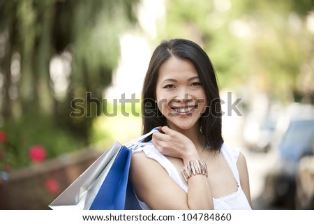 happy japanese woman with shopping bags