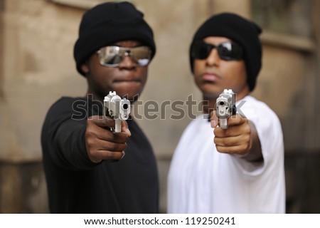Gang members on the street, focus on guns