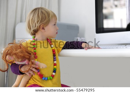 child alone surfing the internet watching DVD video in desktop computer monitors with a large screen