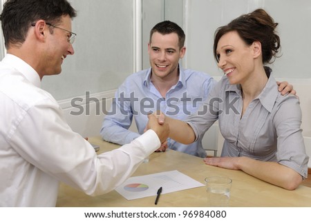 Financial advisor or lawyer giving advice to happy couple