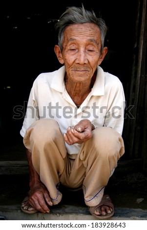 MY SON, VIETNAM - FEBRUARY 02 2007: Elderly man during Tet Holiday New Year Period at My Son Sanctuary in Vietnam.