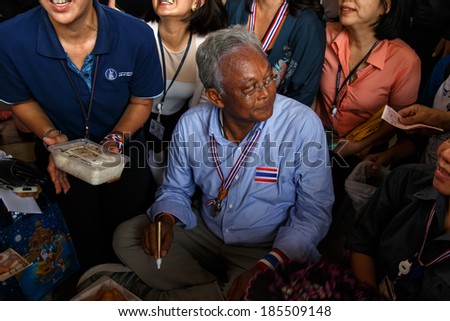 BANGKOK - APRIL 3 2014: Leader Suthep takes money from supporters and signs autograph for protesters near Rama 8 Bridge in Bangkok, Thailand