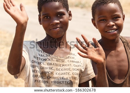 CHOBE, BOTSWANA - OCTOBER 5 2013: Poor African children wander through the desert like Chobe National Park. This year was declared as a drought year by the government in Botswana, Africa