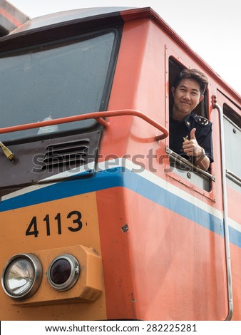 MAE TAN NOI, THAILAND - MARCH 22, 2015: Train driver at remote train station Mae Tan Noi in Northern Thailand.
