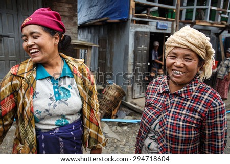 CHIN STATE, MYANMAR - JUNE 23 2015: Friendly ladies in village popular for selling apples in the recently opened to foreigners area of Chin State - western Myanmar (Burma)