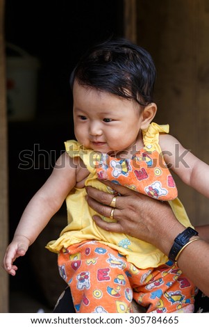 CHIN STATE, MYANMAR - JUNE 18, 2015: Cute young baby girl in the recently opened for tourists Chin State Mountainous Region, Myanmar (Burma)