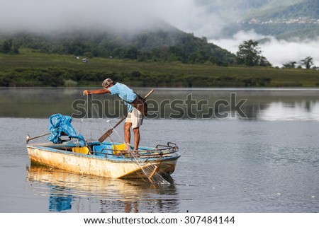 RHI LAKE, MYANMAR - JUNE 21 2015: Local fisherman on the daily fishing trip at the start of the monsoon season in the recently opened to tourists Chin State region of Western Myanmar (Burma)