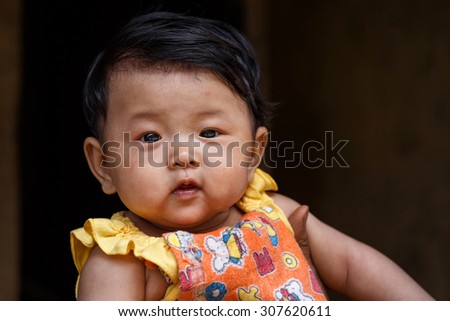 CHIN STATE, MYANMAR - JUNE 18 2015: Cute young baby girl in the recently opened for tourists Chin State Mountainous Region, Myanmar (Burma)