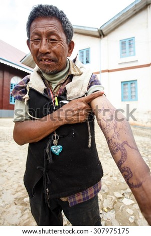 CHIN STATE, MYANMAR - JUNE 18 2015: Tattooed man with homemade pen tattoo in the Chin State Mountainous Region, Myanmar (Burma)