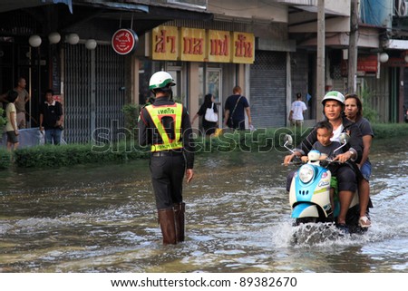 BANGKOK, THAILAND - NOVEMBER 17 : Motorbike navigates the floods after the heaviest rains in 20 years in Thailand on Nov 17, 2011 in Bangkok, Thailand