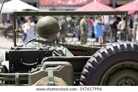 Participant uniform ww2 American soldier driving a car of the era in a recreation of World War two