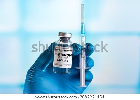 Injectable vaccine for the vaccination program of coronavirus Omicron. Doctor holds the hand Vaccine vial and syringe to administer vaccination doses for New Variant of the Covid-19 Omicron B.1.1.529